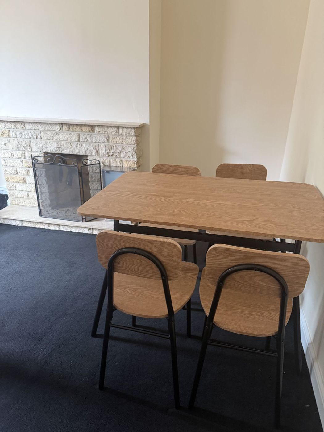 Dining room with table, four chairs and fireplace